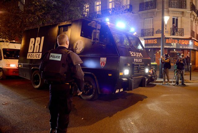 Policemen patrol the streets during gunfire near the Bataclan concert hall on November 13, 2015 in Paris, France. 